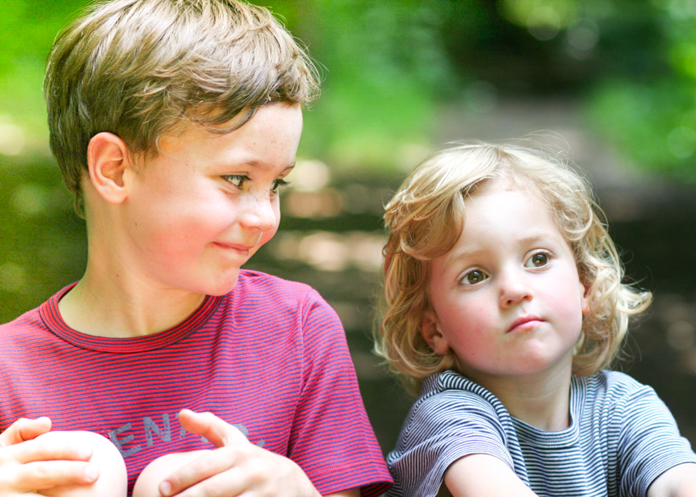 young brothers sitting in the garden