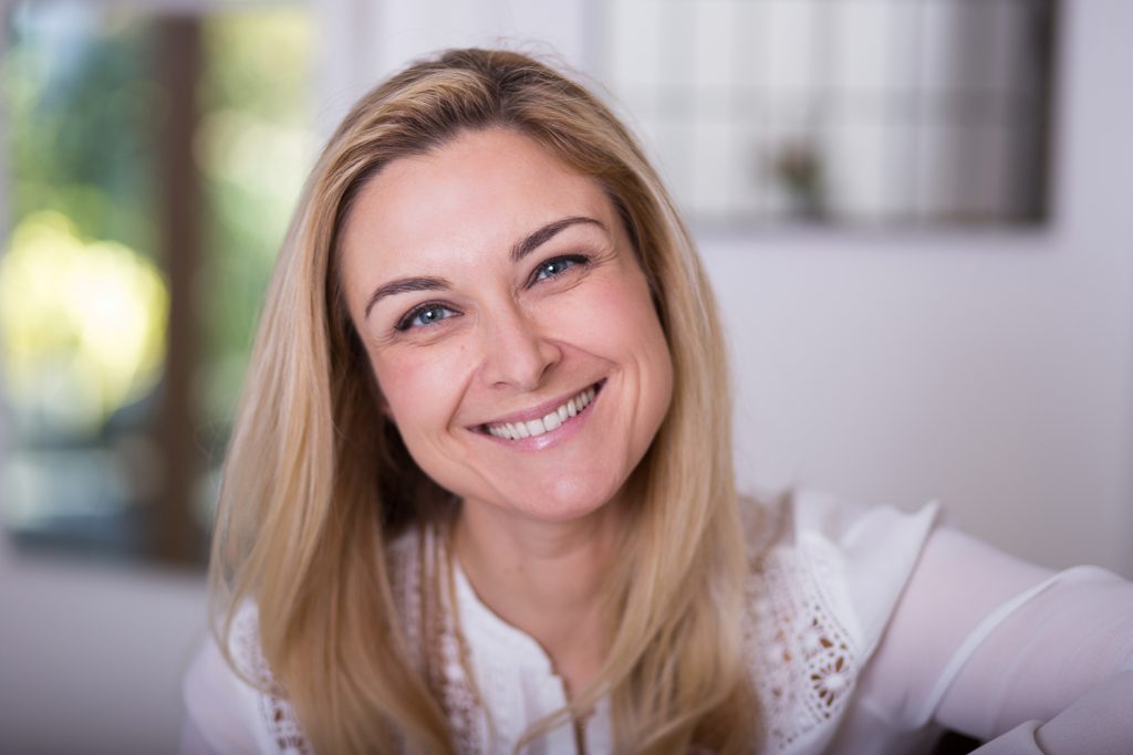 Pretty blonde lady smiling into the camera
