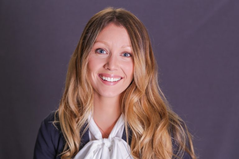 Smiley blonde woman in shirt with bow