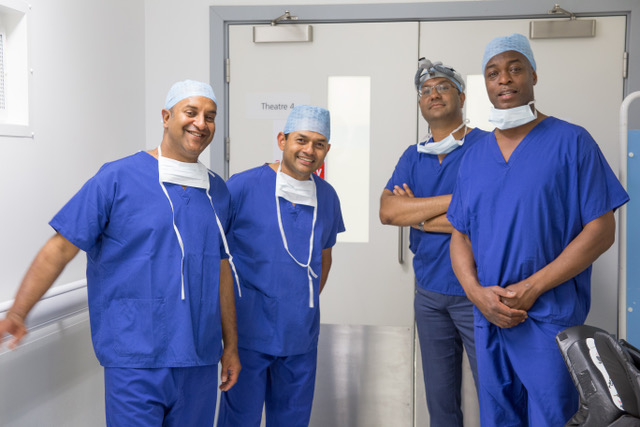 Group of surgeons outside operating theatre in scrubs