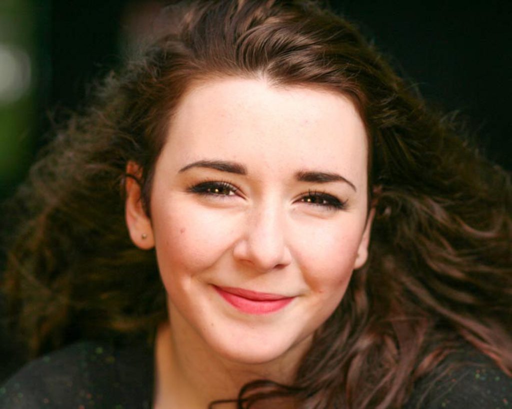 Young pretty actress smiling into the camera