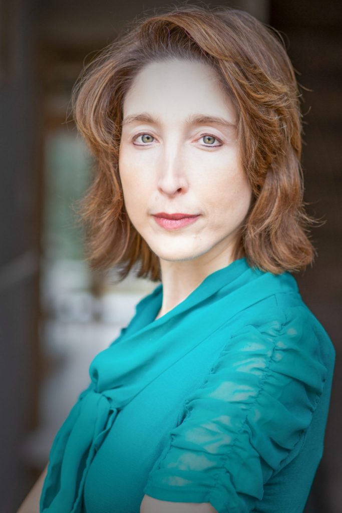 Actress in blue shirt with green eyes