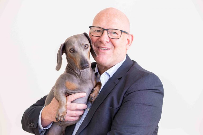 Man with a dog staring into camera